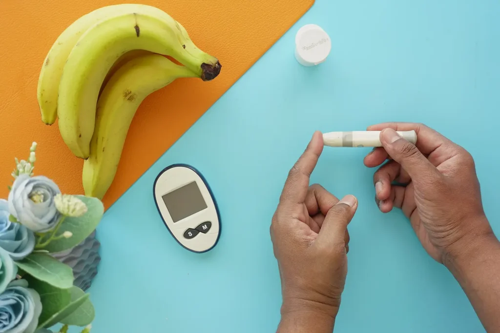 A person's hand measuring blood sugar level with a glucose meter, emphasizing the connection between diabetes management and preventing teeth problems.