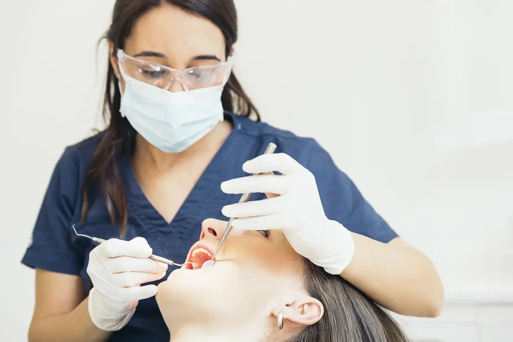 Dentist examining a patient's teeth, addressing issues such as the inability to floss between my teeth due to tight teeth.